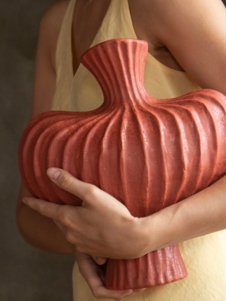 Handmade pottery vase in black showing wabi sabi imperfect beauty